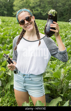 A young woman holding an eggplant Stock Photo