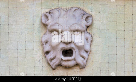 Forli, Italy, wall face sculpture with opened mouth Stock Photo