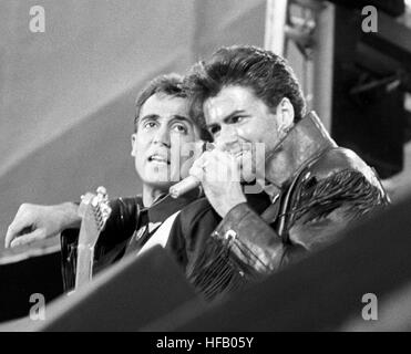 Pop duo Wham partners, Andrew Ridgeley (l) and George Michael, on stage at Wembley Stadium for their sell-out farewell concert. Stock Photo