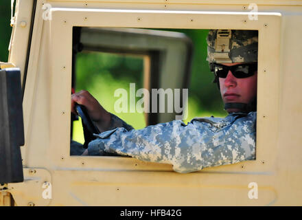 NAVAL STATION GUANTANAMO BAY, Cuba (Sept. 13, 2011) – The driver of a roving patrol unit from the 107th Military Police Company, looks out of the opening of his Humvee.  The 107th MP CO provides external security to Joint Task Force  Guantanamo and fall under the leadership of the 525th Military Police Battalion.  JTF Guantanamo provides safe, humane, legal and transparent care and custody of detainees, including those convicted by military commission and those ordered released by a court. The JTF conducts intelligence collection, analysis and dissemination for the protection of detainees and  Stock Photo