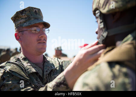 150324-N-WD757-417  SAN DIEGO (March 24, 2015) Chief Electronics Technician Anthony Andersen, left, adjusts Boatswain’s Mate Seaman Ralphaell Punch's, both assigned to Coastal Riverine Squadron (CRS) 3, Kevlar helmet during a field training exercise at Marine Corps Air Station Miramar. CRS-3 is conducting a weeklong training exercise in preparation for their upcoming deployment. (U.S. Navy photo by Mass Communication Specialist 2nd Class Carlos M. Vazquez II/Released) CRS-3 Field Training Exercise 150324-N-WD757-417 Stock Photo