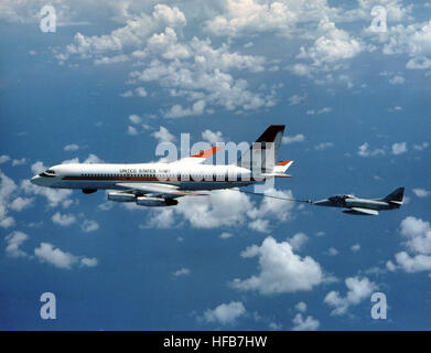 An air-to-air left side view of a UC-880 Convair aircraft assigned to the Naval Air Test Center, Naval Air Station, Patuxent River, refueling a TA-4J Skyhawk aircraft. DN-SC-86-11792 Stock Photo