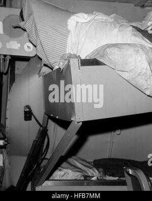 An interior view of damage sustained by the engineering officer's stateroom aboard the guided missile cruiser USS BELKNAP (CG 26).  The BELKNAP was heavily damaged and caught fire when it collided with the aircraft carrier USS JOHN F. KENNEDY (CV 67) during night operations on November 22, 1975. DN-SN-87-07315 USS Belknap distorted beds by collision Stock Photo