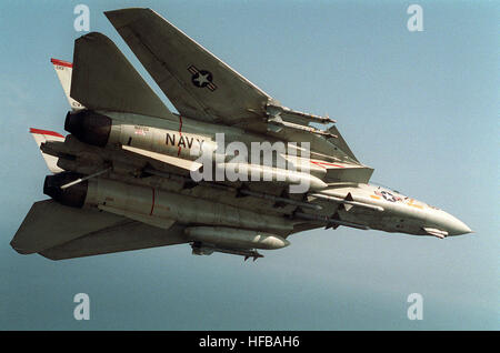 An underside view of a Fighter Squadron 41 (VF-41) F-14A Tomcat aircraft on a Combat Air Patrol (CAP) during Operation Desert Storm.  The aircraft is carrying four AIM-7 Sparrow missiles under its fuselage and two AIM-9 Sidewinder missiles on each wing pylon. F-14A VF-41 DSCAP Stock Photo