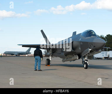 160205-O-ZZ999-923 NAS Patuxent River (February 5, 2016) A member of the Pax River Integrated Test Force (ITF) stands at the ready as Italian Air Force (Aeronautica Militare) aircraft AL-1 — the first F-35 Lightning II international jet fully built overseas at the Cameri Final Assembly & Check-Out (FACO) facility at Cameri Air Base, Italy, — arrives at the Navy’s Electromagnetic Environmental Effects (EEE) test and evaluation laboratory aboard Naval Air Station (NAS) Patuxent River on Feb. 5, 2016. (U.S. Navy photo courtesy Andy Wolfe/Released) F-35A Lightning II completes first trans-Atlantic Stock Photo