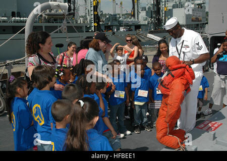 Petty Officer 2nd Class Damien Stone introduces 'Oscar,' a rescue mannequin used for rescue training, to students from Public School 14 in Staten Island while touring the guided-missile cruiser USS Vella Gulf (CG 72) during Fleet Week New York City 2009. Approximately 3,000 Sailors, Marines and Coast Guardsman will participate in the 22nd commemoration of Fleet Week New York. This event will provide the citizens of New York City and the surrounding tri-state area an opportunity to meet service members and also see the latest capabilities of today's maritime services. Fleet Week New York City 2 Stock Photo