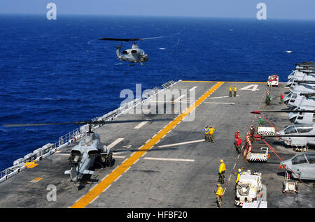 110405-N-ZS026-152  ARABIAN SEA (April 5, 2011) An AH-1 Cobra helicopter assigned to the Evil Eyes of Marine Medium Squadron (HMM) 163 takes off from the amphibious assault ship USS Boxer (LHD 4). Boxer is assigned to Combined Task Force (CTF) 151, a multi-national coalition conducting counter piracy and maritime security operations in the Arabian Sea, Gulf of Aden and Somali Basin. (U.S. Navy photo by Mass Communication Specialist 3rd Class Trevor Welsh/Released)  - Official U.S. Navy Imagery - An H-1 Cobra helicopter takes off from USS Boxer. Stock Photo