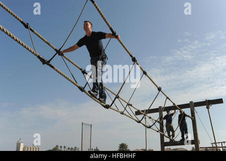 120830-N-KD852-291 SAN DIEGO (Aug. 30, 2012) A chief petty officer (CPO) select maneuvers through the obstacle course at Naval Special Warfare Center during the USS Midway Museum CPO Legacy Academy. The Legacy Academy is a six-day course in which the CPO selects live aboard USS Midway and participate in preservation activities, leadership training, community service projects and learn lessons about the history and heritage of the U.S. Navy and the CPO community. This is the first CPO academy to take place on an aircraft carrier. (U.S. Navy photo by Chief Mass Communication Specialist John Lill Stock Photo