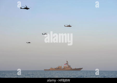 U.S. 5TH FLEET AREA OF RESPONSIBILITY (Oct. 25, 2012) An SH-60B Sea Hawk helicopter from the Proud Warriors of Helicopter Anti-submarine Squadron Light (HSL) 42, Det. 7 and helicopters from the U.S. Army 35th Combat Aviation Brigade conduct a formation flyover of the guided-missile destroyer USS Jason Dunham (DDG 109) following U.S. Army-U.S Navy interoperability training. Jason Dunham is deployed to the U.S. 5th Fleet area of responsibility conducting maritime security operations, theater security cooperation efforts and support missions for Operation Enduring Freedom. America’s Sailors are W Stock Photo