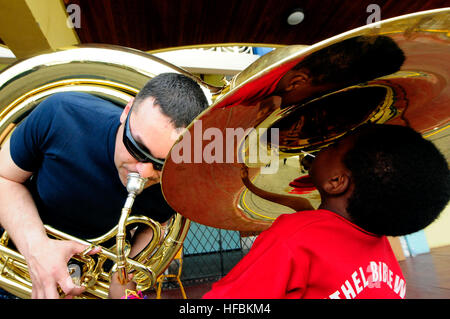 A musician aboard USNS Comfort (T-AH 20) played his tuba for local children during Continuing Promise 2011, a humanitarian assistance mission providing medical and community support in the Caribbean, Central, and South America. Stock Photo