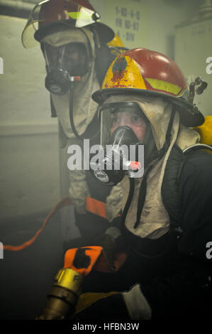 ARABIAN SEA (Oct. 12, 2012) Seaman Scott Hitter, right, and Seaman Samantha Welch fight a simulated fire during a mass casualty drill aboard the amphibious dock landing ship USS Gunston Hall (LSD 44). Gunston Hall is part of the Iwo Jima Amphibious Ready Group with the embarked 24th Marine Expeditionary Unit (24th MEU) and is deployed in support of maritime security operations and theater security cooperation efforts in the U.S. 5th Fleet area of responsibility. The U.S. Navy is reliable, flexible, and ready to respond worldwide on, above, and below the sea. Join the conversation on social med Stock Photo