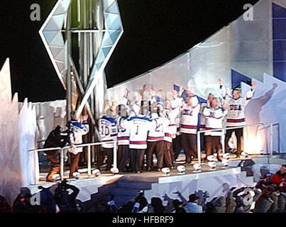 020208-N-3995K-001 Salt Lake City, UT (Feb. 8, 2002) -- Members of the 1980 Gold Medal U.S. Olympic hockey team stand below the Olympic flame after lighting it at Rice-Eccles Olympic Stadium during the opening ceremonies of the 2002 Winter Olympics in Salt Lake City.  The team had the honor of lighting the cauldron to invoke the official start of the competition.  U.S. Navy photo by Journalist 1st Class Preston Keres.  (RELEASED) 2002 Winter Olympics flame - Cropped Stock Photo