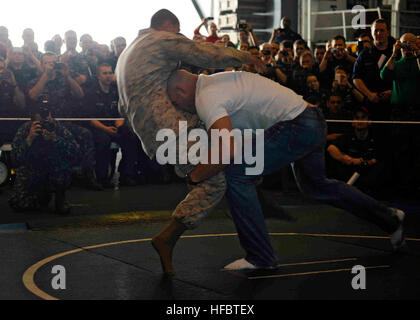 20416-N-FI736-015  ARABIAN GULF (April 16, 2012) Ultimate Fighting Championship (UFC) fighter Keith Jardine demonstrates grappling moves during an exhibition in the hangar bay aboard the aircraft carrier USS Enterprise (CVN 65). Jardine and Rich Franklin, both UFC fighters, visited the ship to meet Sailors and Marines and sign autographs as part of a regional USO tour. Enterprise is deployed to the U.S. 5th Fleet area of responsibility conducting maritime security operations, theater security cooperation efforts and support missions as part of Operation Enduring Freedom. (U.S. Navy photo by Ma Stock Photo