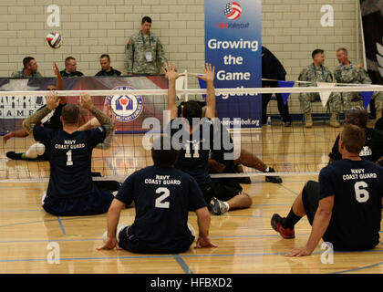 Team Navy/Coast Guard members strategically position themselves in a game of seated volleyball  against Team Army during the 2013 Warrior Games May 14. The Warrior Games includes competitions in archery, cycling, seated volleyball, shooting, swimming, track and field, and wheelchair basketball. The goal of the Warrior Games is not necessarily to identify the most skilled athletes, but rather to demonstrate the incredible potential of wounded warriors through competitive sports. More than 200 wounded, ill, or injured service members from the U.S. and U.K. armed forces are scheduled to compete i Stock Photo