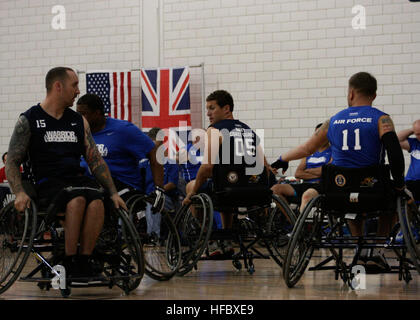 Team Navy/Coast Guard member retired Aviation Electrician's Mate Steven Davis of Turlock, Calif., and retired Operations Specialist 2nd Class Joseph Frank block opposing teammembers in a wheelchair basketball game against Team Air Force during the 2013 Warrior Games May 14. The Warrior Games includes competitions in archery, cycling, seated volleyball, shooting, swimming, track and field, and wheelchair basketball. The goal of the Warrior Games is not necessarily to identify the most skilled athletes, but rather to demonstrate the incredible potential of wounded warriors through competitive sp Stock Photo