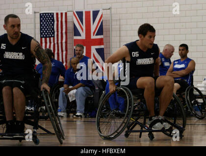Team Navy/Coast Guard member retired Aviation Electrician's Mate Steven Davis of Turlock, Calif., and retired Operations Specialist 2nd Class Joseph Frank, of San Diego, Calif., block opposing team members in a wheelchair basketball game against Team Air Force during the 2013 Warrior Games May 14. The Warrior Games includes competitions in archery, cycling, seated volleyball, shooting, swimming, track and field, and wheelchair basketball. The goal of the Warrior Games is not necessarily to identify the most skilled athletes, but rather to demonstrate the incredible potential of wounded warrior Stock Photo