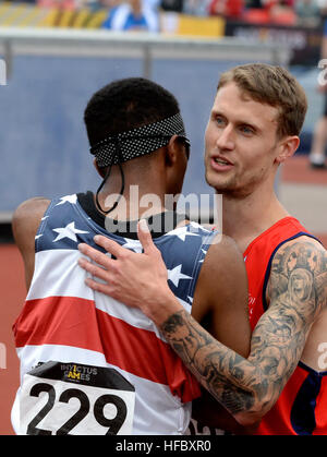 Active duty Navy Hospital Corpsman 3rd Class Angelo Anderson embraces a fellow competitor at the conclusion of a race at the 2014 Invictus Games. The international competition brings together wounded, injured and ill service members in the spirit of friendly athletic competition. American Soldiers, Sailors, Airmen and Marines are representing the United States in the competition which is being held in London, England, Sept. 10-14, 2014. (U.S. Navy photo by Mass Communication Specialist 2nd Class Joshua D. Sheppard/Released) 2014 Invictus Games 140911-N-PW494-543 Stock Photo