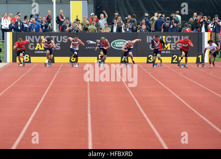 Competitors leave the starting blocks during a 100-meter sprint heat at the 2014 Invictus Games. The international competition brings together wounded, injured and ill service members in the spirit of friendly athletic competition. American Soldiers, Sailors, Airmen and Marines are representing the United States in the competition which is being held in London, England, Sept. 10-14, 2014. (U.S. Navy photo by Mass Communication Specialist 2nd Class Joshua D. Sheppard/Released) 2014 Invictus Games 140911-N-PW494-556 Stock Photo