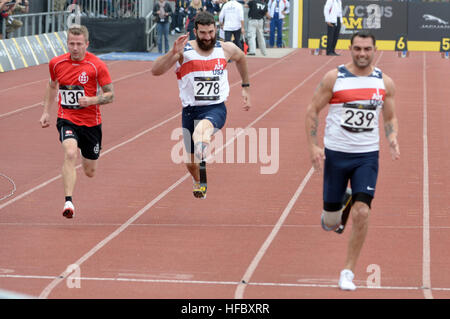 Retired Navy Hospital Corpsman 3rd Class Redmond Ramos competes in a 100 meter sprint heat at the 2014 Invictus Games. The international competition brings together wounded, injured and ill service members in the spirit of friendly athletic competition. American Soldiers, Sailors, Airmen and Marines are representing the United States in the competition which is being held in London, England, Sept. 10-14, 2014. (U.S. Navy photo by Mass Communication Specialist 2nd Class Joshua D. Sheppard/Released) 2014 Invictus Games 140911-N-PW494-609 Stock Photo