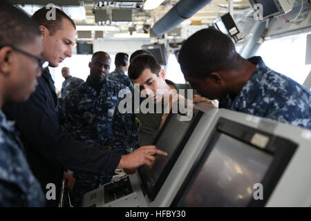 NEWPORT NEWS, Va. (Apr. 14, 2016) -- Lt. Cmdr. James Sullivan. assistant navigator aboard Pre-Commissioning Unit Gerald R. Ford (CVN 78), gives the first training on the steering gear control system during a General Quarters drill. This ship-wide general quarters drill focused on damage control and emergency responses and is a significant step in certifying the crew as they train to fight and take delivery of the ship. (U.S. Navy photo by Mass Communication Specialist Seaman Apprentice Gitte Schirrmacher/Released)(This image was altered for security purposes by blurring out security badges.) F Stock Photo