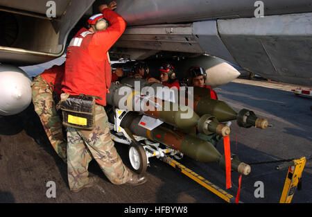 041211-N-4953E-144 Persian Gulf (Dec. 11, 2004) - Aviation Ordnancemen assigned to the ÒSwordsmenÓ of Fighter Squadron Three Two (VF-32) prepare to load 500-pound laser guided bombs (GBU-12) to an F-14B Tomcat aboard the Nimitz-class aircraft carrier USS Harry S. Truman (CVN 75). Carrier Air Wing Three (CVW-3) embarked aboard Truman is providing close air support and conducting intelligence, surveillance and reconnaissance missions over Iraq. TrumanÕs Carrier Strike Group Ten (CSG-10) and CVW-3 are on a regularly scheduled deployment in support of the Global War on Terrorism. U.S. Navy photo b Stock Photo