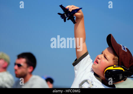 A boy plays with a model of a Blue Angels plane during the Great State of Maine Air Show at Naval Air Station Brunswick. The air show brought performances by the Blue Angels, The U.S. Army Golden Knights parachute team and a wide variety of static displays and interactive exhibits. The show drew more than 150,000 people over three days. This will be the final Navy-sponsored air show at this location before NAS Brunswick is scheduled to close in 2011 by the Base Realignment Commission. Great State of Maine Air Show at Naval Air Station Brunswick 114505 Stock Photo