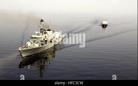 Aerial port bow view of the Royal Navy DUKE CLASS: (Type 23) Frigate, Her MajestyÕs Ship (HMS), PORTLAND (F 79), underway with an Iraqi Commercial Oil Tanker in tow. The Iraqi vessel was boarded and seized after it was found to be carrying an illegal cargo of fuel oil. Activities conducted in support of Operation ENDURING FREEDOM. HMS Portland F79 DNSD0502434 Stock Photo
