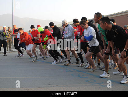 With the starting line marked “Ho Ho Ho,” participants begin the 2011 Santa Runs Tacoma 5K race, a satellite run from Kabul Afghanistan International Airport, Afghanistan, Christmas Day. Approximately 130 people from five countries participated in the run. IJC Santa Runs Tacoma 5K 503561 Stock Photo