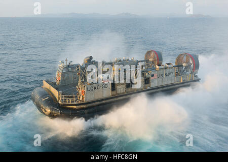 130219-N-LM312-007  GULF OF THAILAND (Feb. 19, 2013) Landing Craft Air Cushion (LCAC) 8, assigned to Naval Beach Unit 7, departs the well deck of the amphibious assault ship USS Bonhomme Richard (LHD 6). The Bonhomme Richard Amphibious Ready Group is deployed in the U.S. 7th Fleet area of responsibility and taking part in Cobra Gold, a Thai-U.S. co-sponsored multinational joint exercise designed to advance regional security by exercising a robust multinational force from nations sharing common goals and security commitments in the Asia-Pacific region. (U.S. Navy photo by Mass Communication Spe Stock Photo