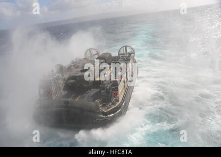 PACIFIC OCEAN (Feb. 9, 2012) Landing Craft Air Cushion (LCAC) 63, assigned to Assault Craft Unit (ACU) 5, departs the well deck of the amphibious assault ship USS Boxer (LHD 4) during exercise Iron Fist 2013. Boxer is currently underway off the coast of Southern California. (U.S. Navy photo by Seaman Veronica Mammina/Released) 130209-N-GM561-025 Join the conversation http://www.facebook.com/USNavy http://www.twitter.com/USNavy http://navylive.dodlive.mil LCAC 63 approaches USS Boxer. (8467237799) Stock Photo