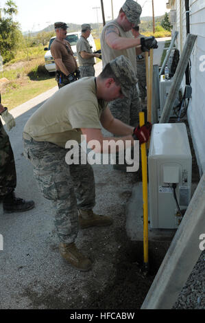 Airmen from the 106th Civil Engineering Squadron of the New York Air National Guard work to reinforce recently-installed air conditioning units at the U.S. Naval Station Guantanamo Bay main chapel, Jan. 18, 2010. Members of the 106th CES are working in support of various engineering and construction projects in support of Joint Task Force Guantanamo and throughout the naval station. Making Improvements Throughout Joint Task Force Guantanamo, U.S. Naval Station Guantanamo Bay 244901 Stock Photo