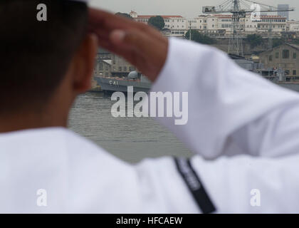 A Sailor assigned to future amphibious assault ship USS America (LHA 6) renders a salute while passing a Brazilian navy frigate as the ship departs Rio De Janeiro following a four-day port visit. America is currently traveling through the U.S. Southern Command and U.S. 4th Fleet area of responsibility on her maiden transit, 'America visits the Americas.' America is the first ship of its class, replacing the Tarawa-class of amphibious assault ships. As the next generation 'big-deck' amphibious assault ship, America is optimized for aviation, capable of supporting current and future aircraft suc Stock Photo