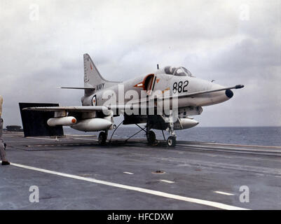 An A-4G Skyhawk aircraft lands on the aircraft carrier HMAS Melbourne (R21) using the carrier's catapult system. The operation demonstrates carrier-based aviation, pilot training, and naval strike capability in support of the Royal Australian Navy's maritime missions. Stock Photo