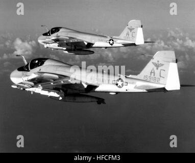 An air-to-air left side view of two A-6E Intruder aircraft from the medium Attack Squadron 75 (AE-75) assigned to the aircraft carrier USS JOHN F. KENNEDY (CV-67).  The front aircraft is armed with an AGM-78 Standard-ARM anti-radiation missile.  The aircraft in the rear is armed with an AGM/RGM-84 Harpoon missile. A-6E Intruders VA-75 in flight 1982 Stock Photo