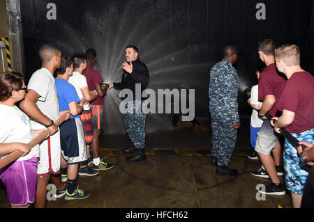 GREAT LAKES, Ill., (June 17, 2015) – Chief Damage Controlman Christopher Gipp, leading chief petty officer of Damage Control “A” School shows Area 3 Navy Junior Reserve Officers' Training Corps (NJROTC) cadets how to properly operate a hose during the annual NJROTC Leadership Academy at Naval Station Great Lakes here, June 17. (U.S. Navy photo Scott A. Thornbloom) NJROTC Leadership Academy at Naval Station Great Lakes 150617-N-IK959-878 Stock Photo