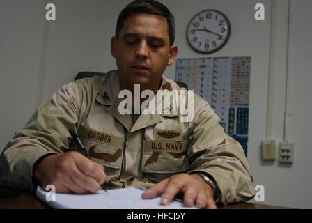 GUANTANAMO BAY, Cuba - Navy Capt. Ken Garber, officer in charge of the Office for the Administrative Review of the Detention of Enemy Combatants-Forward, reviews documents in his office on U.S. Naval Station Guantanamo Bay June 3, 2008. OARDEC makes recommendations to the Deputy Secretary of Defense on whether to release, transfer or continue to detain detainees in Guantanamo Bay. JTF Guantanamo conducts safe and humane care and custody of detained enemy combatants. The JTF conducts interrogation operations to collect strategic intelligence in support of the Global War on Terror and supports l Stock Photo