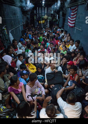 131121-N-NI474-218 - ORMOC, Republic of the Philippines (Nov. 21, 2013) - Families in Ormoc affected by Typhoon Haiyan board an MC-130 Combat Talon II from 1st Special Operation Squadron (1 SOS) Nov. 20 to be transported to Manila as part of Operation Damayan. The Philippine government is closely coordinating ongoing relief efforts including search and rescue, supply drops and personnel airlifts with military and civilian organizations.  (U.S. Navy photo by Mass Communication Specialist 2nd Class Daniel M. Young/Released) Operation Damayan 131121-N-NI474-218 Stock Photo