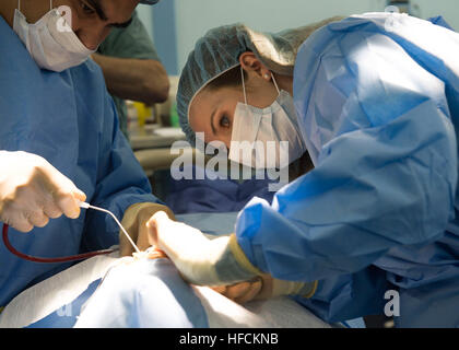 SUBIC BAY, Philippines (Aug. 12, 2015) Ciara Houlihan, an Operation Smile dentist, performs surgery aboard the hospital ship USNS Mercy (T-AH 19) during Pacific Partnership 2015. Mercy is in the Philippines for its third mission port of PP15. Pacific Partnership is in its 10th iteration and is the largest annual multilateral humanitarian assistance and disaster relief preparedness mission conducted in the Indo-Asia-Pacific region. While training for crisis conditions, Pacific Partnership missions to date have provided medical care to approximately 270,000 patients and veterinary services to mo Stock Photo