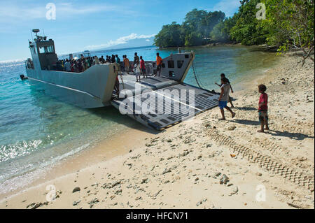 130803-N-WD757-085 VELLA, Solomon Islands (Aug. 3, 2013) Solomon Island citizens and children tour a landing craft medium (LCM) assigned to the Royal New Zealand ship HMNZS Canterbury (LSL-421) after landing ashore to drop off personnel and supplies during Pacific Partnership 2013. Working at the invitation of each host nation, U.S. Navy forces are joined by non-governmental organizations (NGOs) and regional partners that include Australia, Canada, Colombia, France, Japan, Malaysia, Singapore, South Korea, and New Zealand to improve maritime security, conduct humanitarian assistance and streng Stock Photo