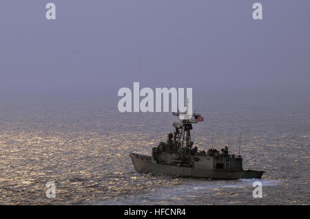 With the sun fighting through the haze in the early morning hours, USS Thach steers to port moving into place for a passing exercise with the Indian Navy's Western Fleet. The PASSEX symbolized the completion of the exercise, which was designed to increase cooperation between the Indian and U.S. Navies while enhancing the cooperative security relationship between India and the U.S.  Ronald Reagan Carrier Strike Group is on a routine deployment in the 7th Fleet area of responsibility. Operating in the Western Pacific and Indian Ocean, the U.S. 7th Fleet is the largest of the forward-deployed U.S Stock Photo