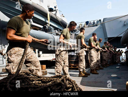 120907-N-XK513-005 GULF OF ADEN (Sept. 7, 2012) - U.S. Marines with the 24th Expeditionary Unit (MEU), tend a line aboard amphibious transport dock ship USS New York (LPD 21) during a replenishment-at-sea with Fleet replenishment oiler USNS Laramie (T-AO 203). New York is part of the Iwo Jima Amphibious Ready Group with the embarked MEU and is currently deployed in support of maritime security operations and theater security cooperation efforts in the U.S. 5th Fleet area of responsibility. (U.S. Navy photo by Mass Communication Specialist 2nd Class Ian Carver/Released). Replenishment at sea 12 Stock Photo