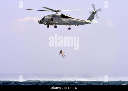 130311-N-XQ375-280  U.S. 5TH FLEET AREA OF RESPONSIBILITY (March 11, 2013) Naval Air Crewmen 2nd Class Jeremiah Angerman is lowered into the water during a search and rescue exercise from an SH-60B Sea Hawk helicopter assigned to the Proud Warriors of Helicopter Anti-Submarine Squadron Light (HSL) 42, Det. 7, embarked aboard the guided-missile destroyer USS Jason Dunham (DDG 109). Jason Dunham is deployed with the John C. Stennis Carrier Strike Group to the U.S. 5th Fleet area of responsibility conducting maritime security operations, theater security cooperation efforts and support missions f Stock Photo