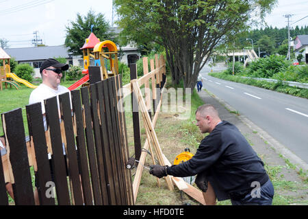 Volunteers from the Naval Air Facility Misawa First Class Petty Officer Association paint a fence of the Bikou-en Childrens Home to help improve safety. (U.S. Navy photo by Petty Officer 2nd Class Matthew M. Bradley/Released) Sailors paint fence at children's home 304018 Stock Photo