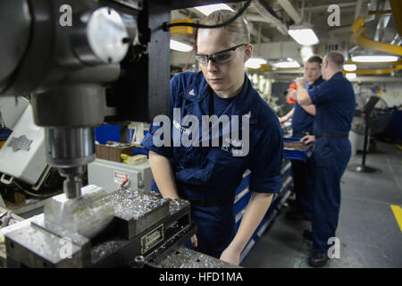 GULF OF OMAN (Dec. 30, 2013) Machinery Repairman 3rd Class Rebecca Babington uses a milling machine in the repair shop of the aircraft carrier USS Harry S. Truman (CVN 75). Harry S. Truman, flagship for the Harry S. Truman Carrier Strike Group, is deployed to the U.S. 5th Fleet area of responsibility conducting maritime security operations, supporting theater security cooperation efforts and supporting Operation Enduring Freedom. (U.S. Navy photo by Mass Communication Specialist Seaman Blagoj B. Petkovski/Released) 131230-N-CC806-043  Join the conversation http://www.facebook.com/USNavy http:/ Stock Photo