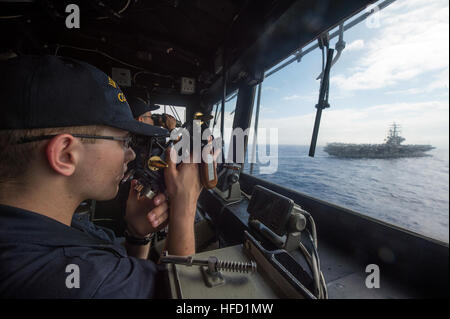 PHILIPPINE SEA (June 18, 2016) Ensign Clayton Dietz takes ranges in the pilot house of the Ticonderoga class guided-missile cruiser USS Shiloh (CG 67), as the ship steams in formation with the Nimitz-class aircraft carriers USS Ronald Reagan (CVN 76) USS John C. Stennis (CVN 74). Shiloh is on patrol supporting the Ronald Reagan Carrier Strike Group. The Nimitz-class aircraft carriers USS John C. Stennis (CVN 74) and USS Ronald Reagan (CVN 76) conduct dual aircraft carrier strike group operations in the U.S. 7th Fleet area of responsibility supporting security and stability in the Indo-Asia Pac Stock Photo