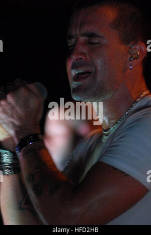 Singer-songwriter Scott Stapp sings one of his hits during a rock concert, put on by Morale, Welfare and Recreation, for the crew of the Nimitz-class aircraft carrier USS Ronald Reagan. Stapp, the former lead singer of Creed, joined the crew of Ronald Regan to meet and greet with the crew. Ronald Reagan is currently deployed to the 5th Fleet/NAVCENT area of responsibility. Operations in the NAVCENT area of operations are focused on reassuring regional partners of the United States' commitment to security, which promotes stability and global prosperity. Scott Stapp performs for USS Ronald Reaga Stock Photo