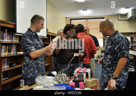Electrician's Mate 1st Class Thomas Bosarge and Navy Counselor 1st Class Robert Aranda, both attached to Navy Recruiting District Houston, help test a remote control for an underwater Remotely Operated Vehicle during a SeaPerch workshop for teachers Sept. 7 at the Women's College Preparatory Academy in Houston.  SeaPerch, an Office of Naval Research sponsored program, is an innovative underwater robotics program that equips teachers and students with the resources they need to build an underwater ROV in an in-school or out-of-school setting. (U.S. Navy photo by Mass Communication Specialist 1s Stock Photo