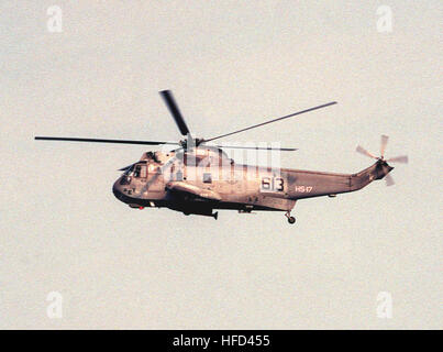 A Helicopter Anti-submarine Squadron 17 (HS-17) SH-3H Sea King helicopter flies over the Chesapeake Bay. SH-3H Sea King of HS-17 in flight in August 1990 Stock Photo