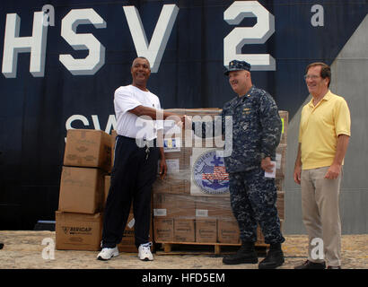 Lt. Cmdr. Ken Cremeans, center, deputy mission commander of Southern Partnership Station 2010, shakes hands with representatives from the Garrison Secondary School as they receive school supplies donated from Project Handclasp and delivered by High Speed Vessel Swift in Bridgetown, Barbados. Swift is deployed supporting Southern Partnership Station, a deployment of various specialty platforms to the U.S. Southern Command area of responsibility. (U.S. Navy photo by Petty Officer 1st Class Rachael L. Leslie) Southern Partnership Station (SPS) 2010 310643 Stock Photo