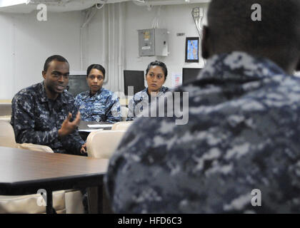 A Seaman Apprentice on USS Boxer participates in a SPAWAR training session covering computer server architecture, information technology, and security to support C4I readiness across Navy fleet units. Stock Photo